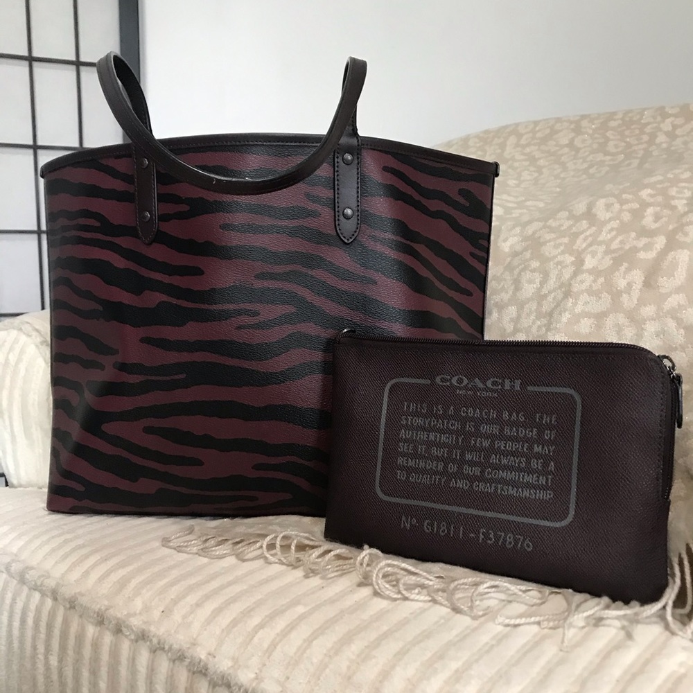 Coach satchel bag large , color is maroon and black and this bag is reversible .